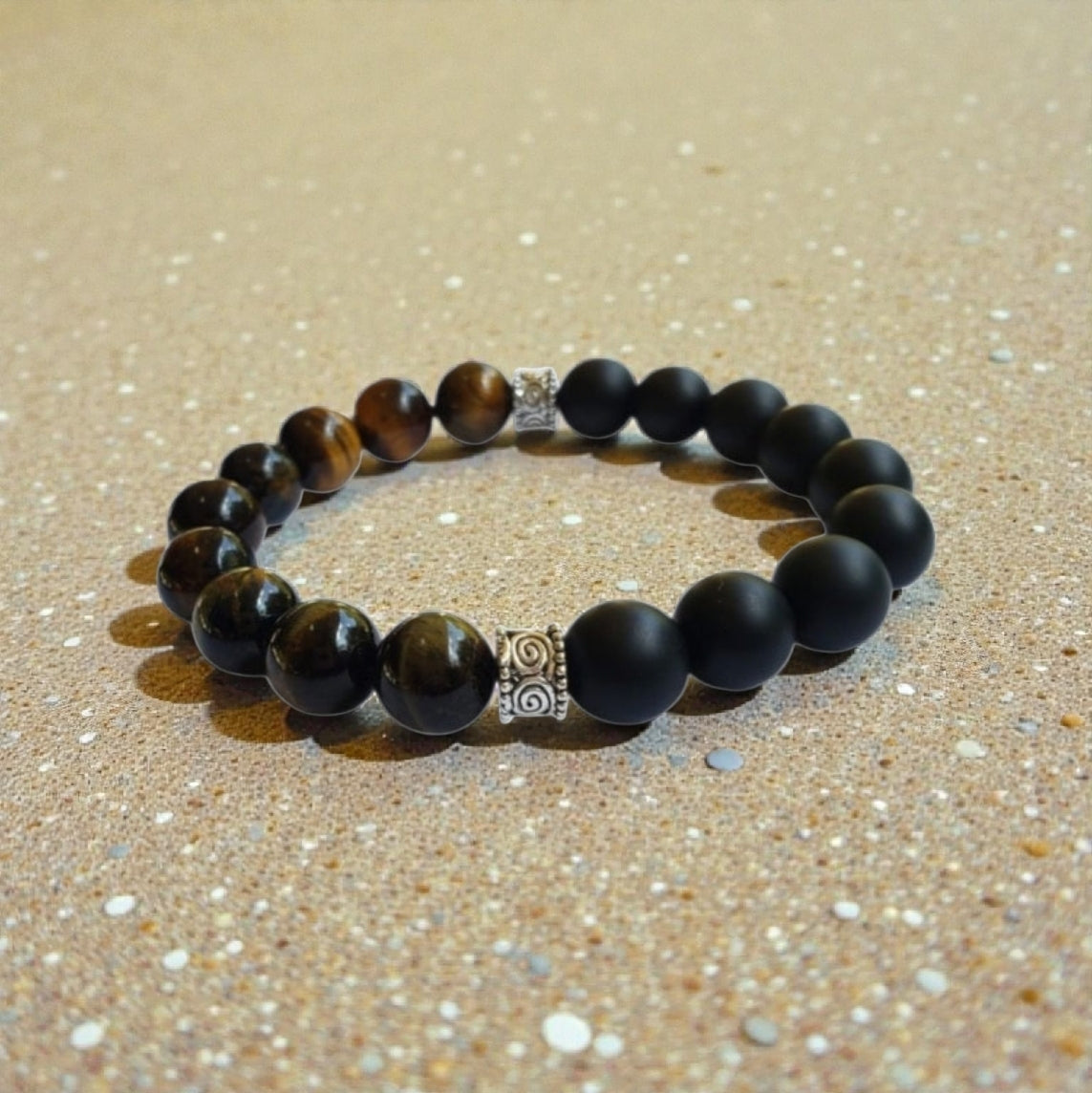 Handmade men’s bracelet featuring natural tiger’s eye and black onyx stones set in a sleek sterling silver bar design. This stylish accessory combines powerful lucky charm stones, known for their protective and grounding properties, making it an ideal birthday gift or meaningful jewelry piece. Perfect for men who appreciate handcrafted, elegant, and masculine jewelry that blends natural elements with modern style.