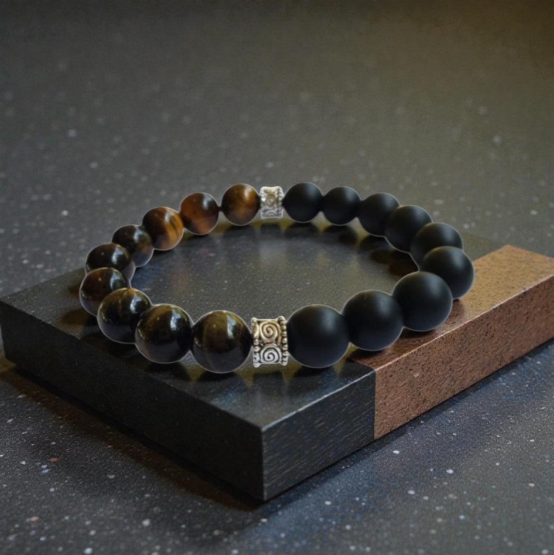 Handmade men’s bracelet featuring natural tiger’s eye and black onyx stones set in a sleek sterling silver bar design. This stylish accessory combines powerful lucky charm stones, known for their protective and grounding properties, making it an ideal birthday gift or meaningful jewelry piece. Perfect for men who appreciate handcrafted, elegant, and masculine jewelry that blends natural elements with modern style.