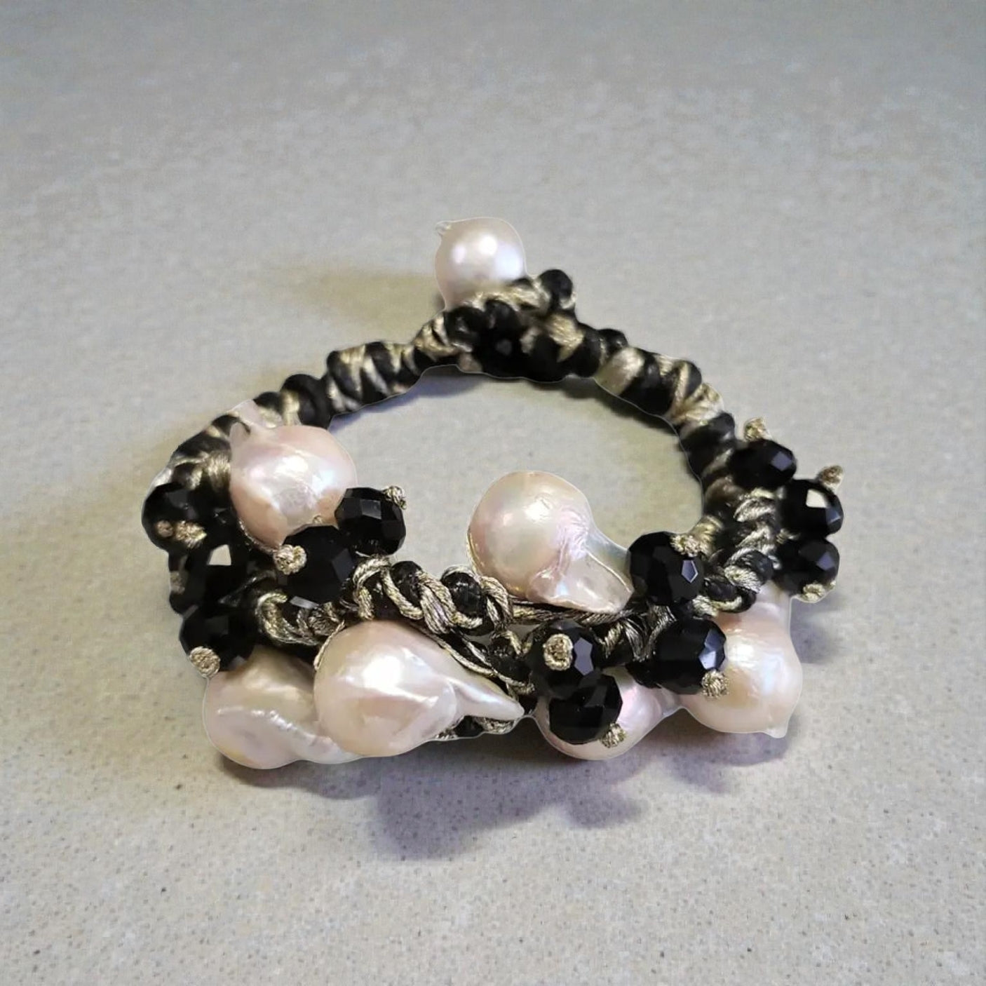 Black and gold Edison pearl bracelet featuring lustrous freshwater pearls accented with elegant gold-toned details for a timeless, sophisticated look. This handcrafted bracelet blends classic elegance with modern style, making it perfect for formal events, weddings, or everyday luxury. A thoughtful jewelry gift for women, anniversaries, birthdays, or special occasions, this pearl bracelet adds refined beauty and a touch of glamour to any outfit.