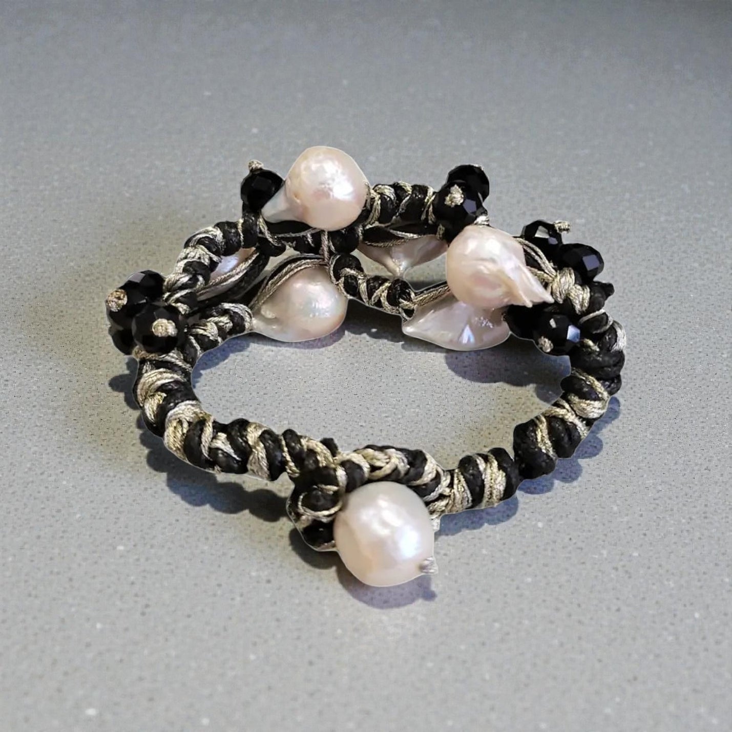 Black and gold Edison pearl bracelet featuring lustrous freshwater pearls accented with elegant gold-toned details for a timeless, sophisticated look. This handcrafted bracelet blends classic elegance with modern style, making it perfect for formal events, weddings, or everyday luxury. A thoughtful jewelry gift for women, anniversaries, birthdays, or special occasions, this pearl bracelet adds refined beauty and a touch of glamour to any outfit.