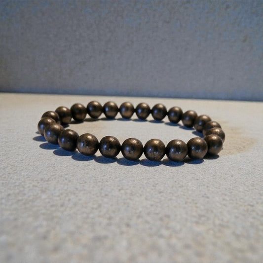 Good Luck Pyrite Bracelet featuring handmade crystal beads designed to attract abundance and positive spiritual energy. This unisex bracelet combines shimmering pyrite stones with artisanal craftsmanship, making it a meaningful gift for both women and men. Lightweight and stylish, it promotes confidence, prosperity, and protection. Perfect for everyday wear or meditation, this abundance bracelet blends healing properties with modern boho jewelry aesthetics.