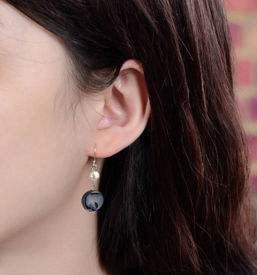 Handmade Abalone Shell Drop Earrings featuring iridescent coin shell pearls in a lightweight dangle design. These dainty and unique earrings for women showcase natural abalone hues with shimmering color shifts, making them a stunning accessory for any outfit. A perfect gift for her, these artisanal earrings blend elegance and simplicity, ideal for birthdays, anniversaries, or special occasions. Stylish, feminine, and one of a kind.