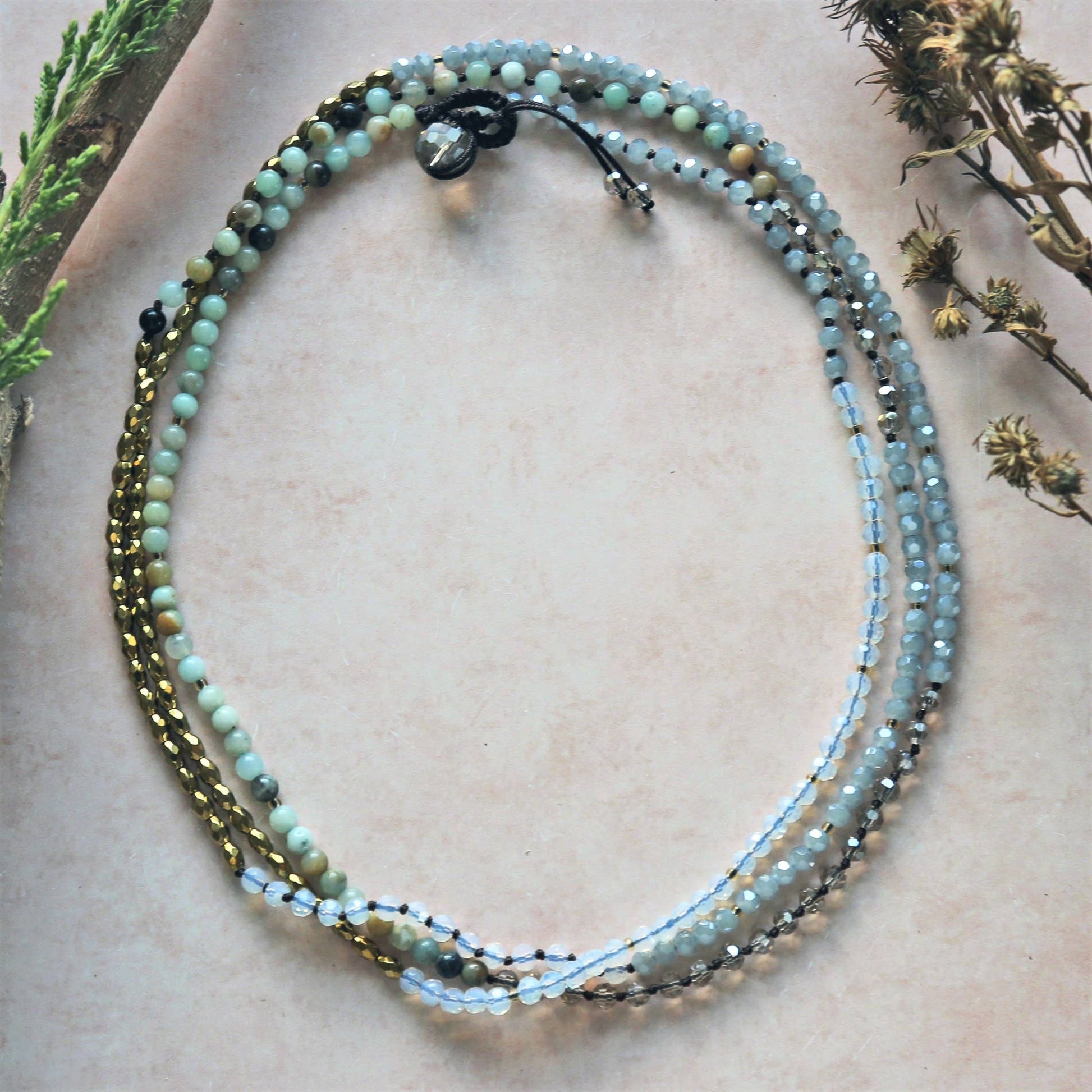 Minimalist Amazonite Hematite Necklace featuring a delicate handmade design with calming amazonite and grounding hematite gemstones. This women’s gemstone jewelry piece blends natural beauty with boho chic style, perfect for layering or wearing alone. Lightweight and versatile, it’s an ideal gift for her on birthdays, holidays, or special occasions. Combining spiritual energy with understated elegance, this necklace adds a peaceful, earthy touch to any modern outfit.
