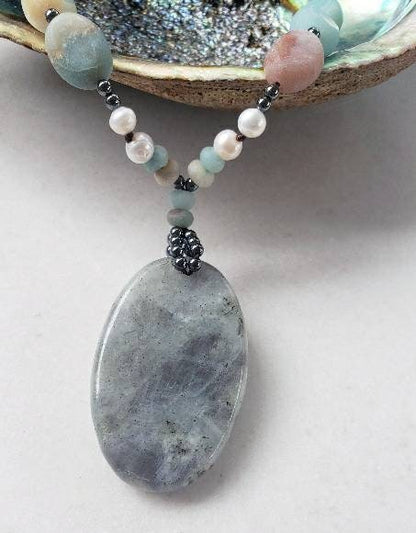 Amazonite and labradorite crystal necklace for women featuring a natural gemstone pendant with soothing tones and subtle shimmer. This handmade statement necklace blends calming amazonite with the iridescent glow of labradorite, offering both beauty and spiritual meaning. Perfect for boho or everyday wear, it makes a thoughtful gift for her. Crafted with care, this unique piece adds a touch of elegance and grounding energy to any jewelry collection