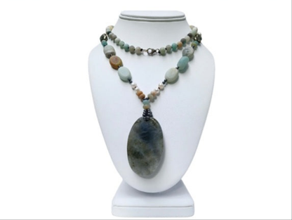 Long beaded amazonite necklace for women featuring pearls, labradorite, hematite, and pyrite for a bold statement look. This handcrafted necklace blends soft and earthy tones with natural gemstones known for their beauty and healing properties. Perfect for layering or wearing alone, it adds elegance to boho and everyday styles. A unique gift for her, this versatile necklace brings together calming energy and sophisticated design in one stunning piece.