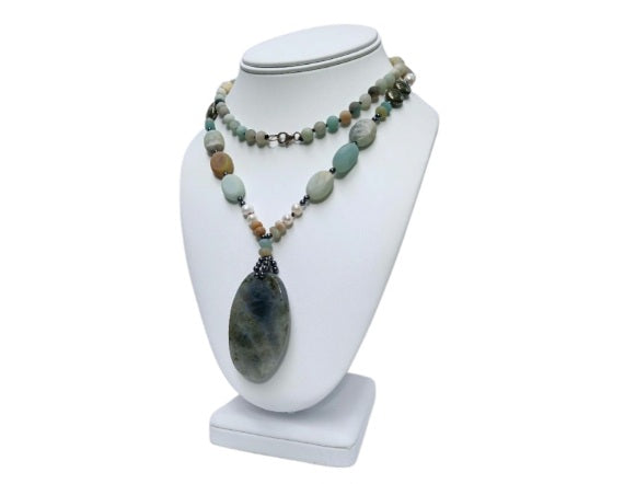 Long beaded amazonite necklace for women featuring pearls, labradorite, hematite, and pyrite for a bold statement look. This handcrafted necklace blends soft and earthy tones with natural gemstones known for their beauty and healing properties. Perfect for layering or wearing alone, it adds elegance to boho and everyday styles. A unique gift for her, this versatile necklace brings together calming energy and sophisticated design in one stunning piece.