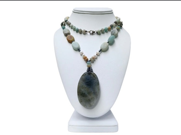 Long beaded amazonite necklace for women featuring pearls, labradorite, hematite, and pyrite for a bold statement look. This handcrafted necklace blends soft and earthy tones with natural gemstones known for their beauty and healing properties. Perfect for layering or wearing alone, it adds elegance to boho and everyday styles. A unique gift for her, this versatile necklace brings together calming energy and sophisticated design in one stunning piece.