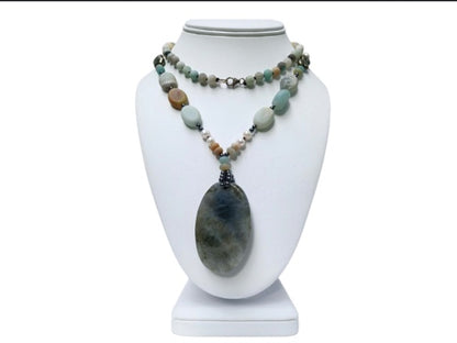 Long beaded amazonite necklace for women featuring pearls, labradorite, hematite, and pyrite for a bold statement look. This handcrafted necklace blends soft and earthy tones with natural gemstones known for their beauty and healing properties. Perfect for layering or wearing alone, it adds elegance to boho and everyday styles. A unique gift for her, this versatile necklace brings together calming energy and sophisticated design in one stunning piece.