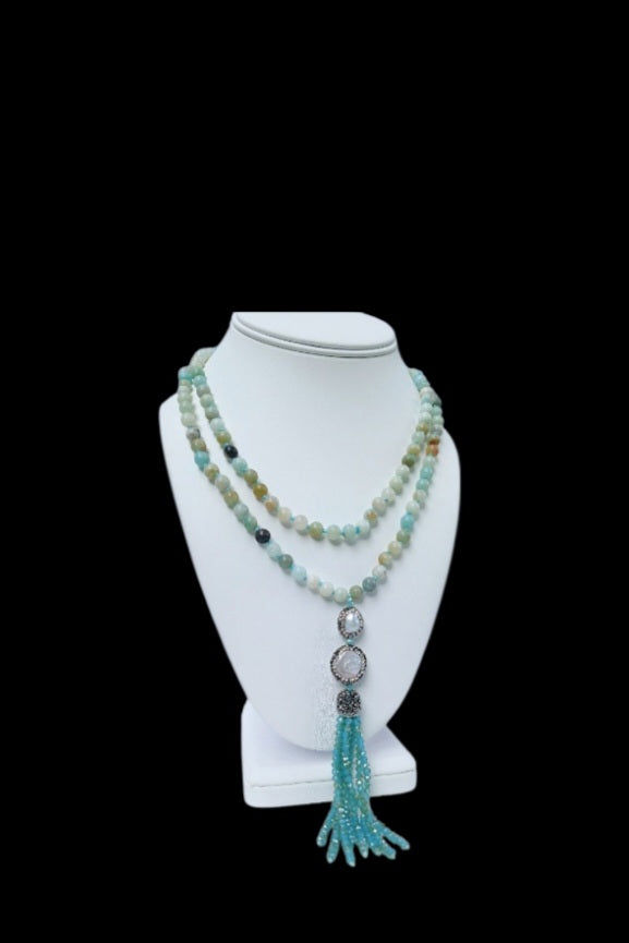 Handmade 21-inch Amazonite and Pearl Tassel Necklace featuring natural gemstones designed to promote success, abundance, and calm energy. This long yoga necklace combines soothing amazonite beads with elegant pearls and a stylish tassel, perfect for meditation or everyday wear. Lightweight and beautifully crafted, it makes a meaningful gift for her seeking balance, positivity, and spiritual growth through gemstone jewelry.
