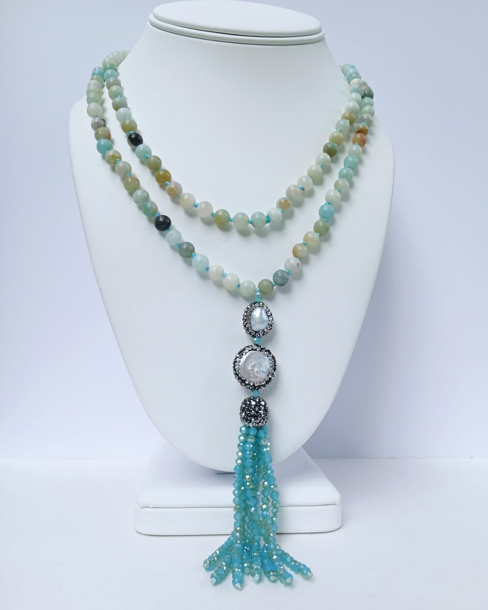 Handmade 21-inch Amazonite and Pearl Tassel Necklace featuring natural gemstones designed to promote success, abundance, and calm energy. This long yoga necklace combines soothing amazonite beads with elegant pearls and a stylish tassel, perfect for meditation or everyday wear. Lightweight and beautifully crafted, it makes a meaningful gift for her seeking balance, positivity, and spiritual growth through gemstone jewelry.