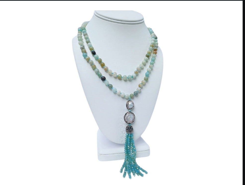 Handmade 21-inch Amazonite and Pearl Tassel Necklace featuring natural gemstones designed to promote success, abundance, and calm energy. This long yoga necklace combines soothing amazonite beads with elegant pearls and a stylish tassel, perfect for meditation or everyday wear. Lightweight and beautifully crafted, it makes a meaningful gift for her seeking balance, positivity, and spiritual growth through gemstone jewelry.