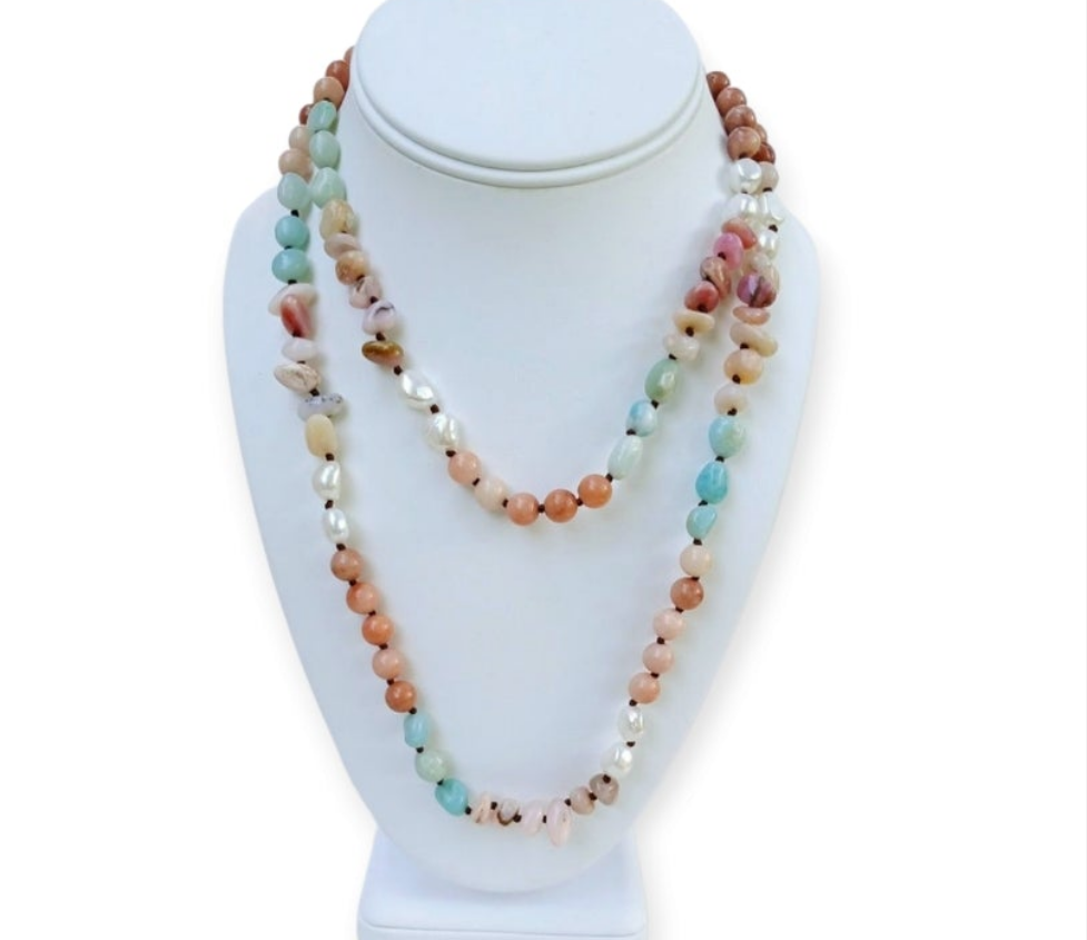 Handmade long necklace featuring natural amazonite and agate gemstones in green and blue hues, designed as a vintage-inspired statement crystal jewelry piece. This unique accessory blends earthy elegance with artisanal craftsmanship, perfect for women who appreciate handcrafted gemstone jewelry. Ideal as a Christmas gift for her, it adds a pop of color and spiritual energy to any outfit, suitable for both casual and formal occasions.