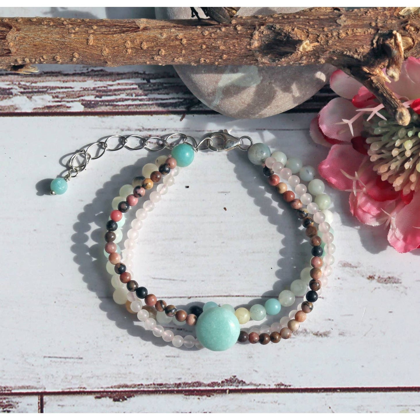 Beautiful multi-strand beaded bracelet for women featuring Amazonite, Rhodonite, Rose Quartz, and freshwater Pearls, accented with sterling silver details. This handmade healing gemstone jewelry promotes emotional balance and love, making it a meaningful gift for her. Perfect for special occasions or everyday wear, this elegant bracelet combines natural colors and textures for a stylish, feminine accessory that enhances any outfit