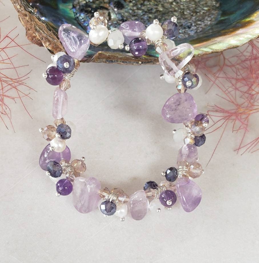 Amethyst Pearl Multi-Stone Stretch Bracelet featuring natural crystal beads designed for style and healing. This chakra bracelet includes amethyst, freshwater pearls, and complementary gemstones to promote balance, clarity, and calm energy. Perfect for those who love natural stone jewelry with spiritual meaning, this handcrafted beaded bracelet is a beautiful accessory for yoga, meditation, or everyday wear—combining elegance, wellness, and boho-inspired charm.