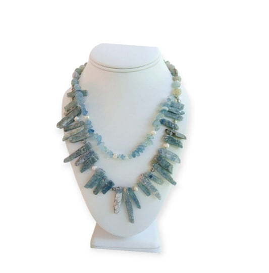 Elegant handmade necklace featuring Aquamarine, Kyanite, and freshwater Pearls, designed for women who love natural aqua-toned jewelry. This unique piece combines soft blue and white hues for a calming, ocean-inspired look. Perfect as a gift for her or a stylish addition to your own jewelry collection, it’s ideal for birthdays, anniversaries, or special occasions. A delicate yet striking women’s necklace crafted with care and intention.