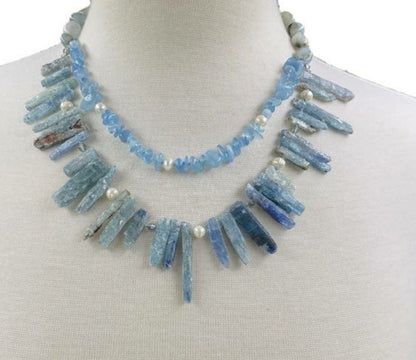 Elegant handmade necklace featuring Aquamarine, Kyanite, and freshwater Pearls, designed for women who love natural aqua-toned jewelry. This unique piece combines soft blue and white hues for a calming, ocean-inspired look. Perfect as a gift for her or a stylish addition to your own jewelry collection, it’s ideal for birthdays, anniversaries, or special occasions. A delicate yet striking women’s necklace crafted with care and intention.