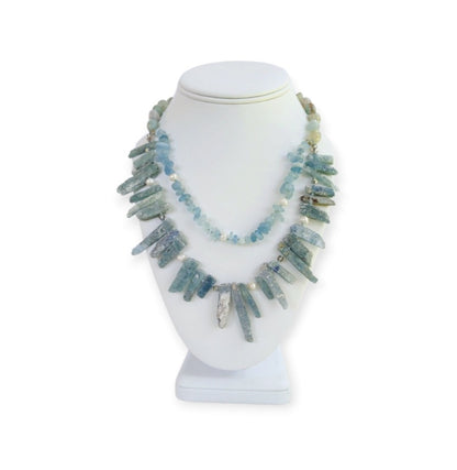 Elegant handmade necklace featuring Aquamarine, Kyanite, and freshwater Pearls, designed for women who love natural aqua-toned jewelry. This unique piece combines soft blue and white hues for a calming, ocean-inspired look. Perfect as a gift for her or a stylish addition to your own jewelry collection, it’s ideal for birthdays, anniversaries, or special occasions. A delicate yet striking women’s necklace crafted with care and intention.