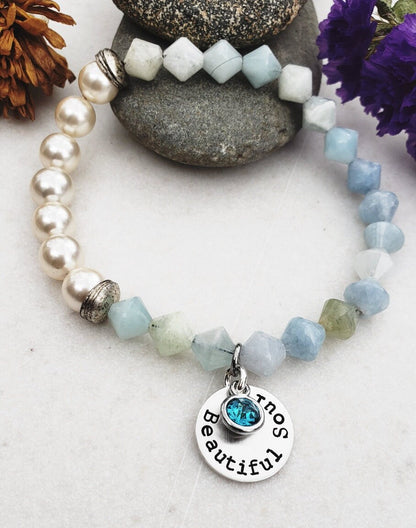 Aquamarine Pearl Bracelet featuring handmade beaded design combining soothing aquamarine stones with lustrous pearls. This inspirational jewelry piece is perfect as a March birthstone gift, symbolizing calmness, courage, and good luck. Ideal for her or as a thoughtful mother’s gift, it blends elegant style with meaningful healing properties. Lightweight and versatile, this bracelet adds a delicate, spiritual touch to everyday wear or special occasions, celebrating love and positive energy.