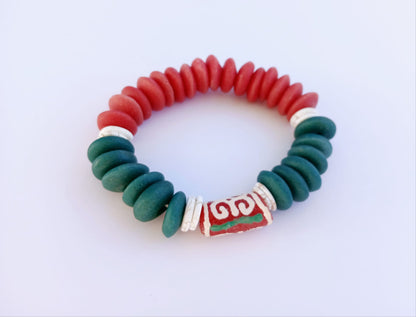 Ashanti-inspired green, red, and white glass beaded bracelet featuring bold, chunky African jewelry design. Handcrafted to reflect rich cultural heritage, this vibrant bracelet blends traditional African artistry with Native American and Southwestern style influences. A striking gift for her, perfect for those who appreciate unique, ethnic accessories that celebrate identity, color, and craftsmanship