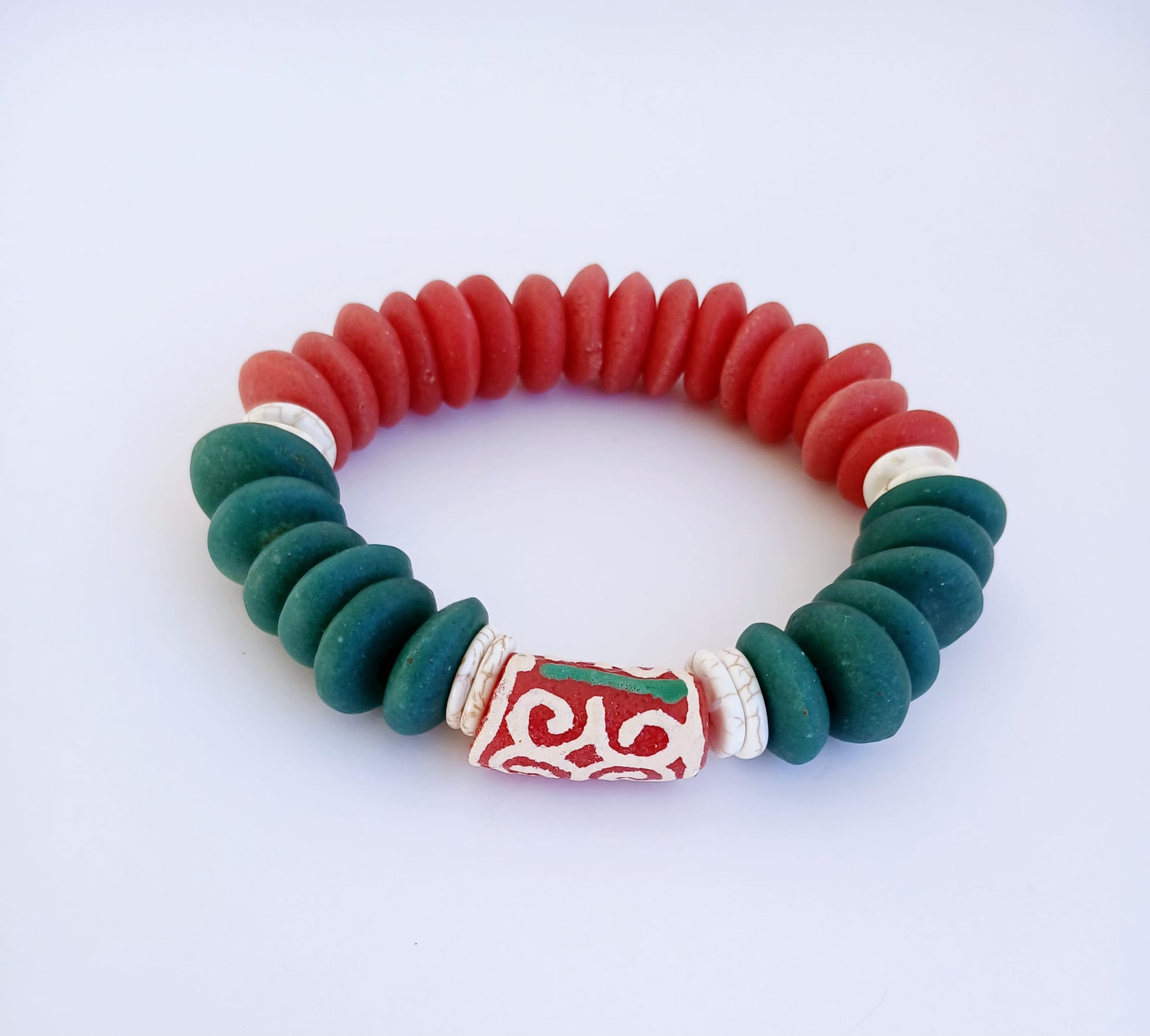 Ashanti-inspired green, red, and white glass beaded bracelet featuring bold, chunky African jewelry design. Handcrafted to reflect rich cultural heritage, this vibrant bracelet blends traditional African artistry with Native American and Southwestern style influences. A striking gift for her, perfect for those who appreciate unique, ethnic accessories that celebrate identity, color, and craftsmanship