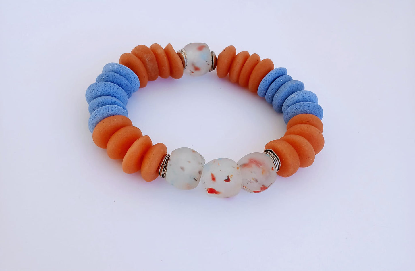 Orange and Blue Ashanti Glass Beaded Bracelet featuring multicolor handmade beads crafted into a vibrant healing jewelry piece for men and women. This lucky charm bracelet blends traditional Ashanti craftsmanship with modern style, promoting positive energy and spiritual balance. Lightweight and durable, it makes a meaningful gift for him or her, perfect for everyday wear or special occasions, combining artisanal quality with bold, colorful design.