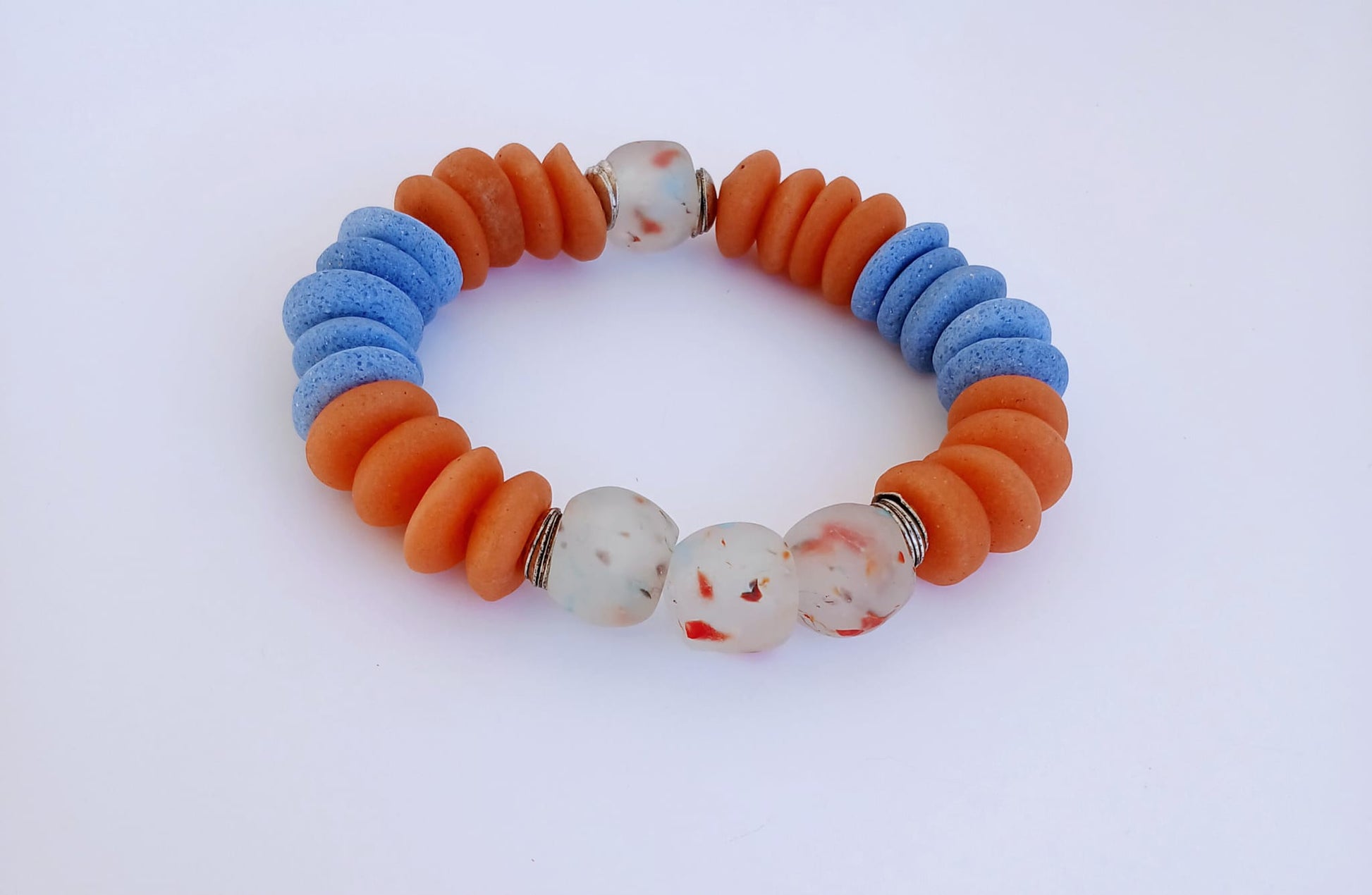 Orange and Blue Ashanti Glass Beaded Bracelet featuring multicolor handmade beads crafted into a vibrant healing jewelry piece for men and women. This lucky charm bracelet blends traditional Ashanti craftsmanship with modern style, promoting positive energy and spiritual balance. Lightweight and durable, it makes a meaningful gift for him or her, perfect for everyday wear or special occasions, combining artisanal quality with bold, colorful design.