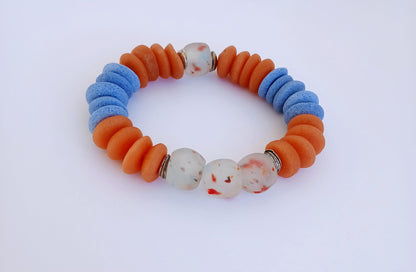 Orange and Blue Ashanti Glass Beaded Bracelet featuring multicolor handmade beads crafted into a vibrant healing jewelry piece for men and women. This lucky charm bracelet blends traditional Ashanti craftsmanship with modern style, promoting positive energy and spiritual balance. Lightweight and durable, it makes a meaningful gift for him or her, perfect for everyday wear or special occasions, combining artisanal quality with bold, colorful design.