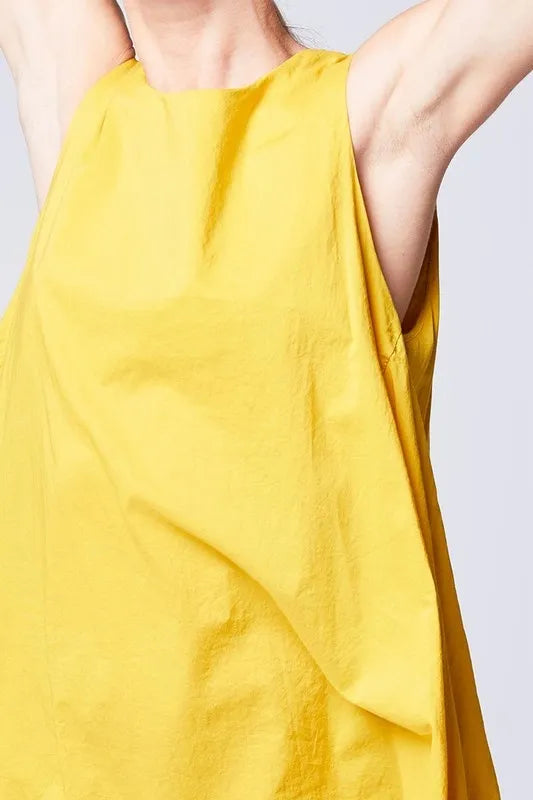 Asymmetrical Midi Tank Dress in mustard color crafted from soft cotton, designed for women seeking stylish comfort. This sleeveless, oversized summer dress features a unique asymmetrical hemline and breathable fabric, making it perfect for casual boho-inspired looks. Made in Italy with high-quality craftsmanship, it blends relaxed fit with elegant design for warm-weather outings or laid-back gatherings.
