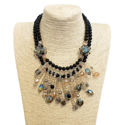 Aurora Borealis crystal and onyx bead necklace featuring a cascading statement design for women who love bold, elegant style. This gothic glam necklace sparkles with iridescent crystals and deep black beads, perfect for evening wear or special occasions. A stunning gift for her, it blends dark romance with shimmering beauty. Ideal for gothic, vintage, or glam-inspired looks, this necklace adds drama and sophistication to any outfit.