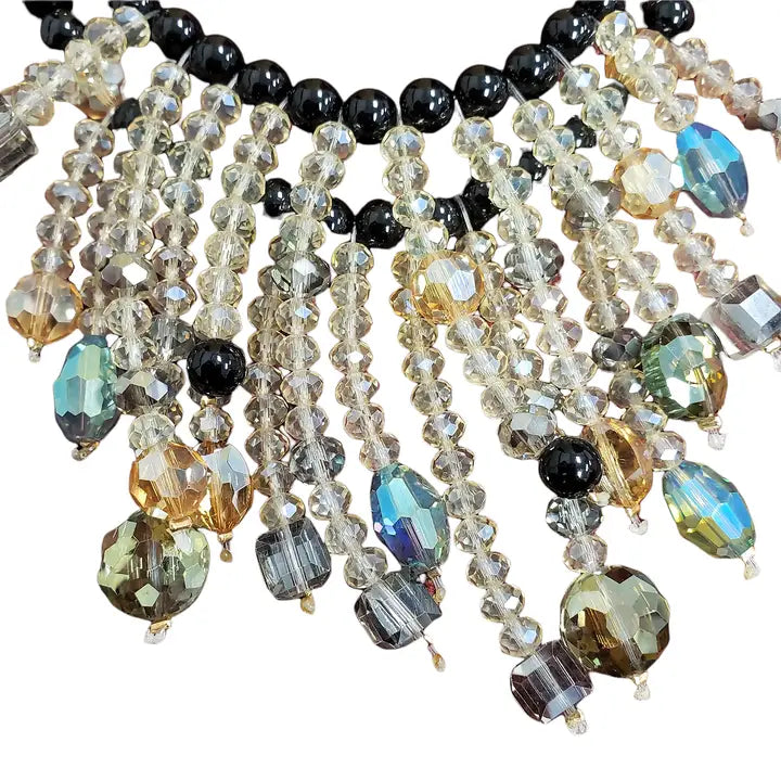 Aurora Borealis crystal and onyx bead necklace featuring a cascading statement design for women who love bold, elegant style. This gothic glam necklace sparkles with iridescent crystals and deep black beads, perfect for evening wear or special occasions. A stunning gift for her, it blends dark romance with shimmering beauty. Ideal for gothic, vintage, or glam-inspired looks, this necklace adds drama and sophistication to any outfit.