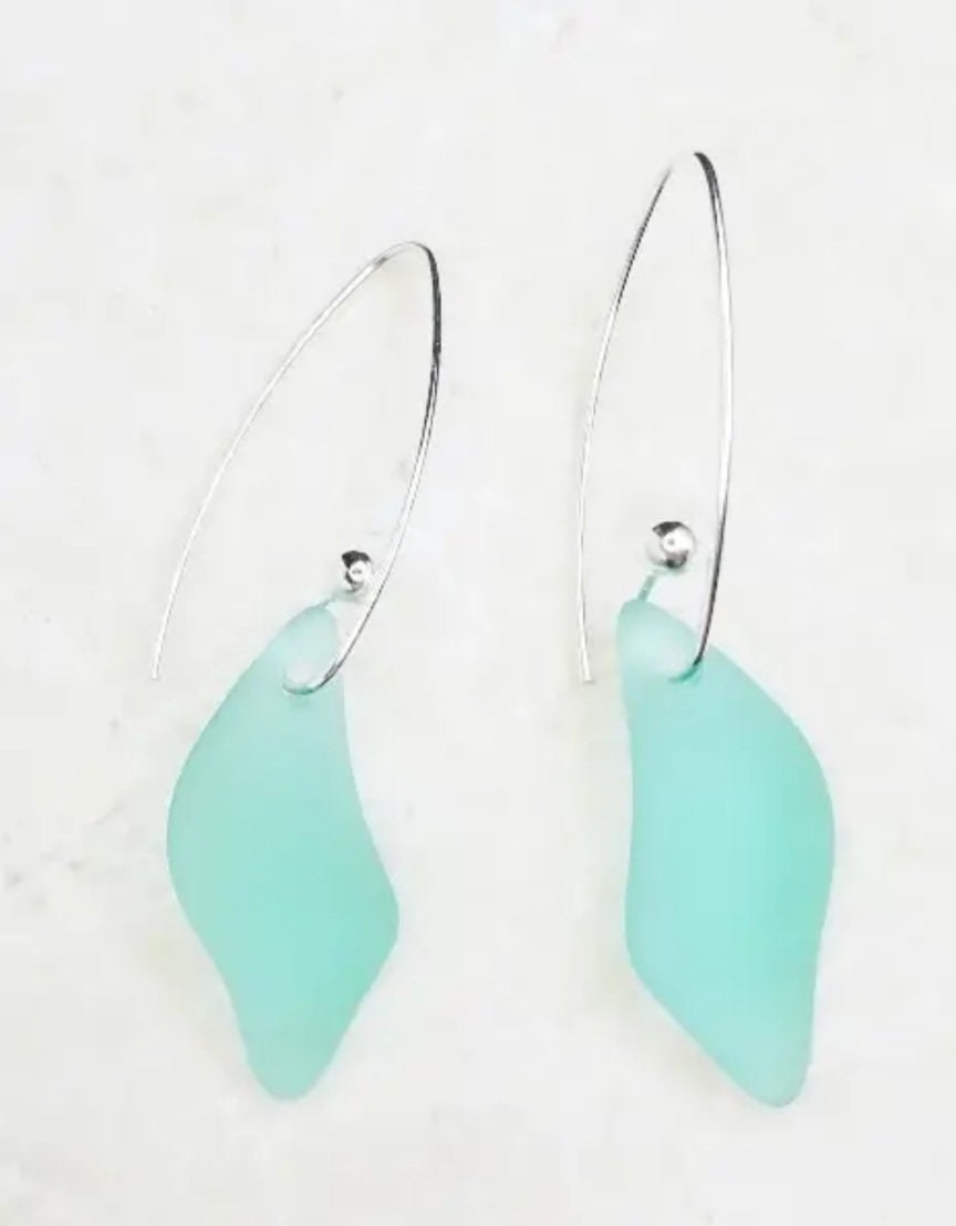 Sea Glass Hoop Earrings designed with marquis splash dangle accents in rich autumn green tones. These handmade, boho-inspired earrings offer a unique and artistic touch, perfect for women who love natural, earthy jewelry. Lightweight and stylish, they make a standout accessory for any season. A thoughtful and unique gift choice for birthdays, holidays, or special occasions, celebrating artisan craftsmanship and coastal charm.