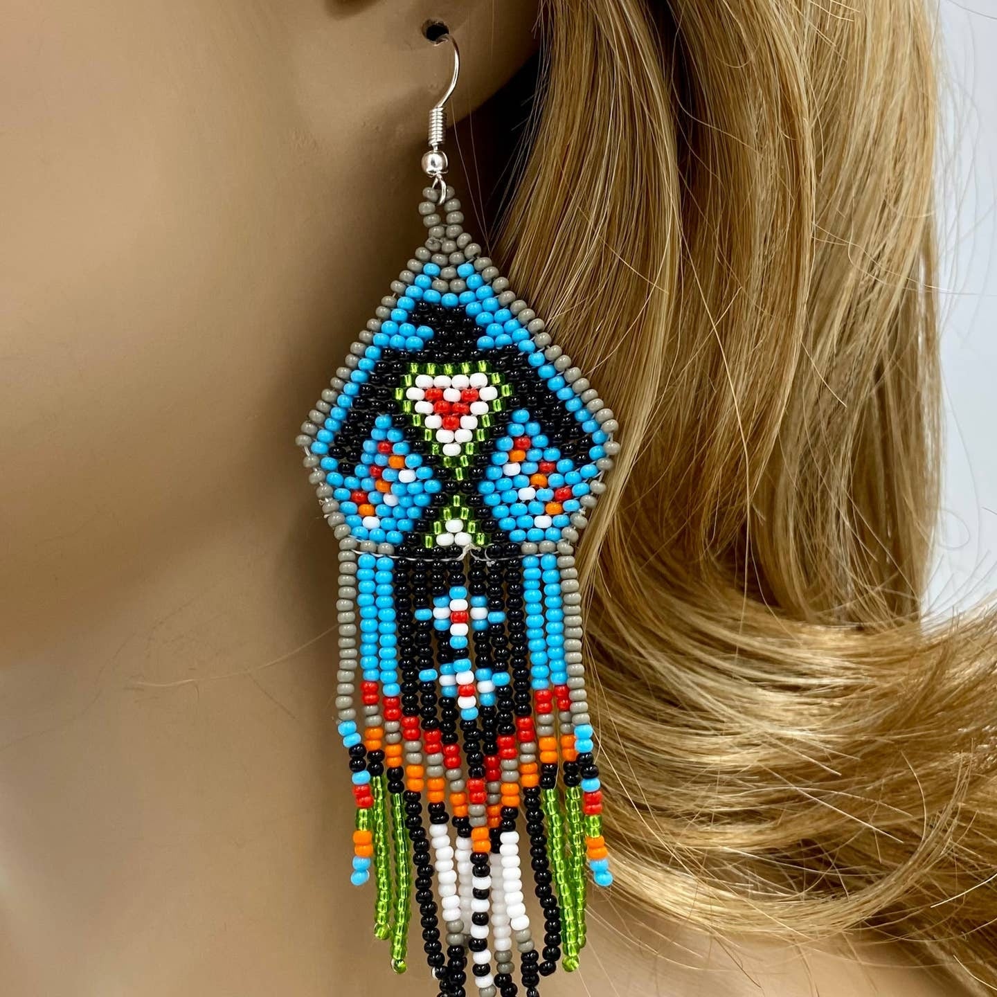 Beaded Eagle Handmade Earrings featuring a bold Native bohemian design in striking blue and black tones. These large, lightweight statement earrings are crafted with intricate beadwork to create a powerful eagle motif, symbolizing strength and freedom. Perfect for women who love unique boho jewelry with a cultural flair, these eye-catching earrings add a distinctive tribal touch to festival outfits, casual wear, or artistic fashion ensembles.
