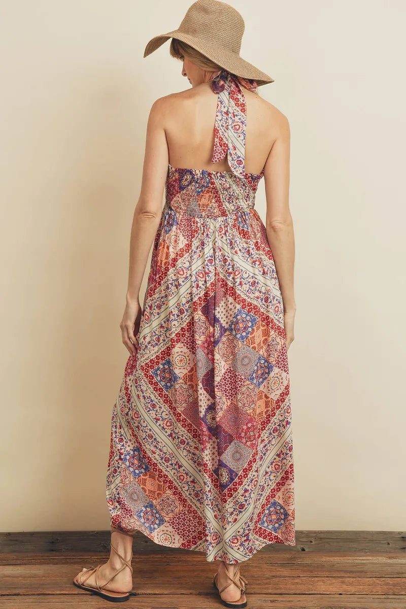 Berry Paisley Halter Dress is a boho-inspired maxi dress featuring a vibrant paisley print and a halter necktie for adjustable comfort. The baby doll bodice with a smocked back panel offers a flattering fit, while the flowy silhouette creates effortless summer style. Perfect as a casual maxi dress for warm weather, beach outings, or relaxed gatherings, this dress blends playful design with comfortable, breezy wear.