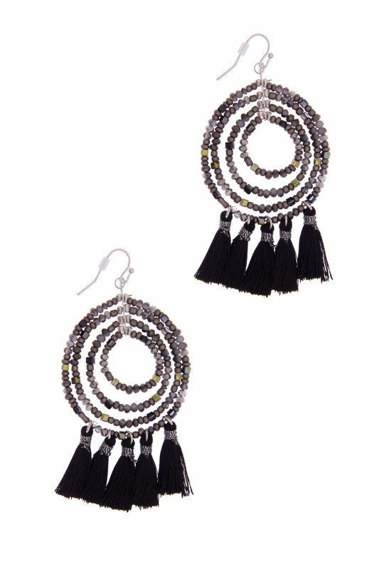 Black Beaded Hoop Earrings with Tassel featuring a bold boho design perfect for women who love trendy, handmade statement jewelry. These eye-catching earrings showcase intricate black beadwork and flowing tassels that add movement and texture to any outfit. Lightweight and stylish, they make a thoughtful gift for her, ideal for birthdays, festivals, or everyday wear. Crafted with care, these earrings offer a chic, free-spirited look that blends modern fashion with artisanal flair.