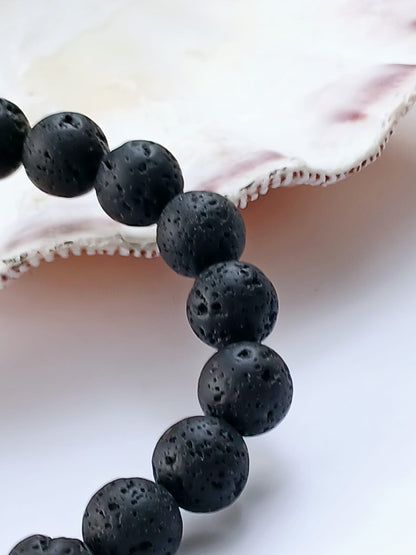 Black lava diffuser bracelet handmade with natural stone beads, designed for both men and women. This stylish aromatherapy accessory allows you to apply essential oils for calming, grounding benefits throughout the day. A thoughtful anniversary gift or wellness-inspired jewelry piece, it combines rugged elegance with holistic function. Perfect for daily wear, stress relief, and a natural touch of style