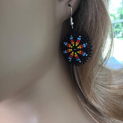 Handmade black native beaded earrings featuring southwestern-inspired design with black and blue beads. These boho tribal dangle earrings combine traditional craftsmanship with modern style, perfect for women who love unique statement jewelry. Lightweight and vibrant, they add a bold touch to any outfit. Ideal as a thoughtful gift for her, these earrings celebrate cultural artistry and complement bohemian and tribal fashion styles effortlessly