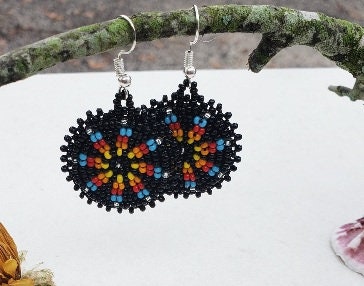 Handmade black native beaded earrings featuring southwestern-inspired design with black and blue beads. These boho tribal dangle earrings combine traditional craftsmanship with modern style, perfect for women who love unique statement jewelry. Lightweight and vibrant, they add a bold touch to any outfit. Ideal as a thoughtful gift for her, these earrings celebrate cultural artistry and complement bohemian and tribal fashion styles effortlessly