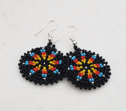 Handmade black native beaded earrings featuring southwestern-inspired design with black and blue beads. These boho tribal dangle earrings combine traditional craftsmanship with modern style, perfect for women who love unique statement jewelry. Lightweight and vibrant, they add a bold touch to any outfit. Ideal as a thoughtful gift for her, these earrings celebrate cultural artistry and complement bohemian and tribal fashion styles effortlessly
