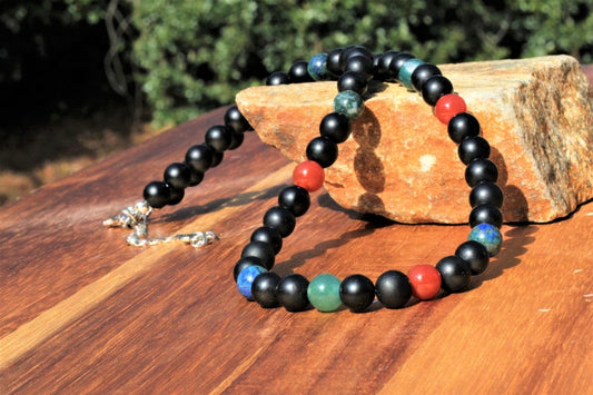 Black Onyx Carnelian Lapis Lazuli Necklace featuring a handcrafted combination of powerful crystals designed for chakra healing and spiritual balance. This unique necklace blends black onyx, vibrant carnelian, and deep blue lapis lazuli stones, making it perfect for men and women who appreciate meaningful, artisan jewelry. Ideal as a spiritual gift, it promotes energy alignment and holistic wellness while adding natural beauty and style to everyday wear or meditation practice.