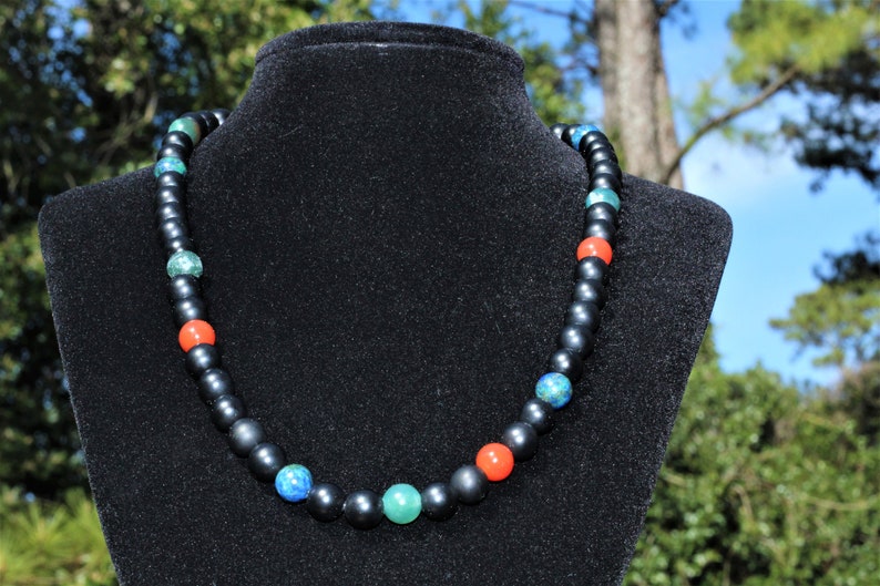 Black Onyx Carnelian Lapis Lazuli Necklace featuring a handcrafted combination of powerful crystals designed for chakra healing and spiritual balance. This unique necklace blends black onyx, vibrant carnelian, and deep blue lapis lazuli stones, making it perfect for men and women who appreciate meaningful, artisan jewelry. Ideal as a spiritual gift, it promotes energy alignment and holistic wellness while adding natural beauty and style to everyday wear or meditation practice.