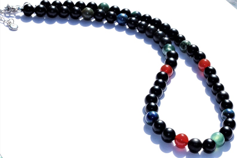 Black Onyx Carnelian Lapis Lazuli Necklace featuring a handcrafted combination of powerful crystals designed for chakra healing and spiritual balance. This unique necklace blends black onyx, vibrant carnelian, and deep blue lapis lazuli stones, making it perfect for men and women who appreciate meaningful, artisan jewelry. Ideal as a spiritual gift, it promotes energy alignment and holistic wellness while adding natural beauty and style to everyday wear or meditation practice.