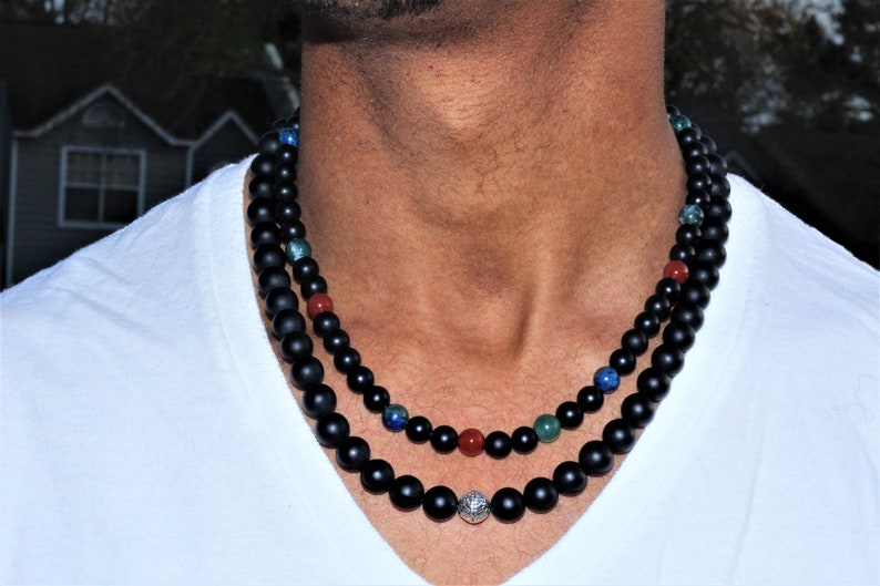 Black Onyx Carnelian Lapis Lazuli Necklace featuring a handcrafted combination of powerful crystals designed for chakra healing and spiritual balance. This unique necklace blends black onyx, vibrant carnelian, and deep blue lapis lazuli stones, making it perfect for men and women who appreciate meaningful, artisan jewelry. Ideal as a spiritual gift, it promotes energy alignment and holistic wellness while adding natural beauty and style to everyday wear or meditation practice.