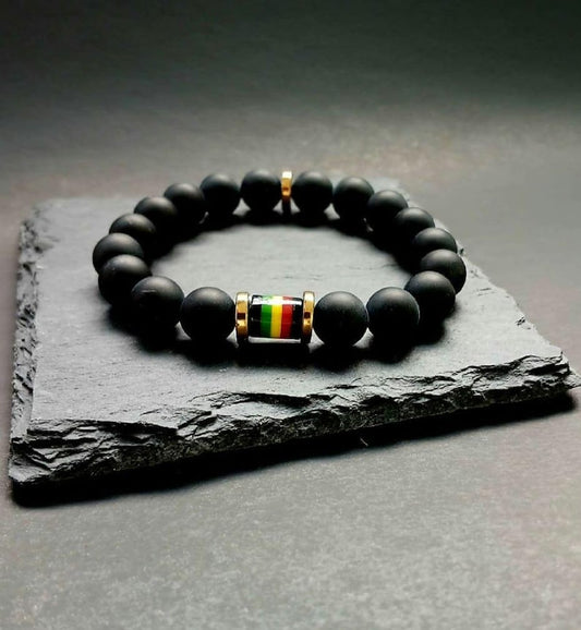 Black Onyx Beaded Rasta Bracelet featuring vibrant reggae colors, handmade with natural gemstone beads for men who love boho and Rastafarian-inspired style. This unisex bracelet symbolizes protection, strength, and cultural pride, making it a meaningful gift for him. Perfect for casual wear, festivals, or spiritual occasions, it blends bold colors with grounding black onyx stones. A stylish accessory that celebrates heritage and positive energy.