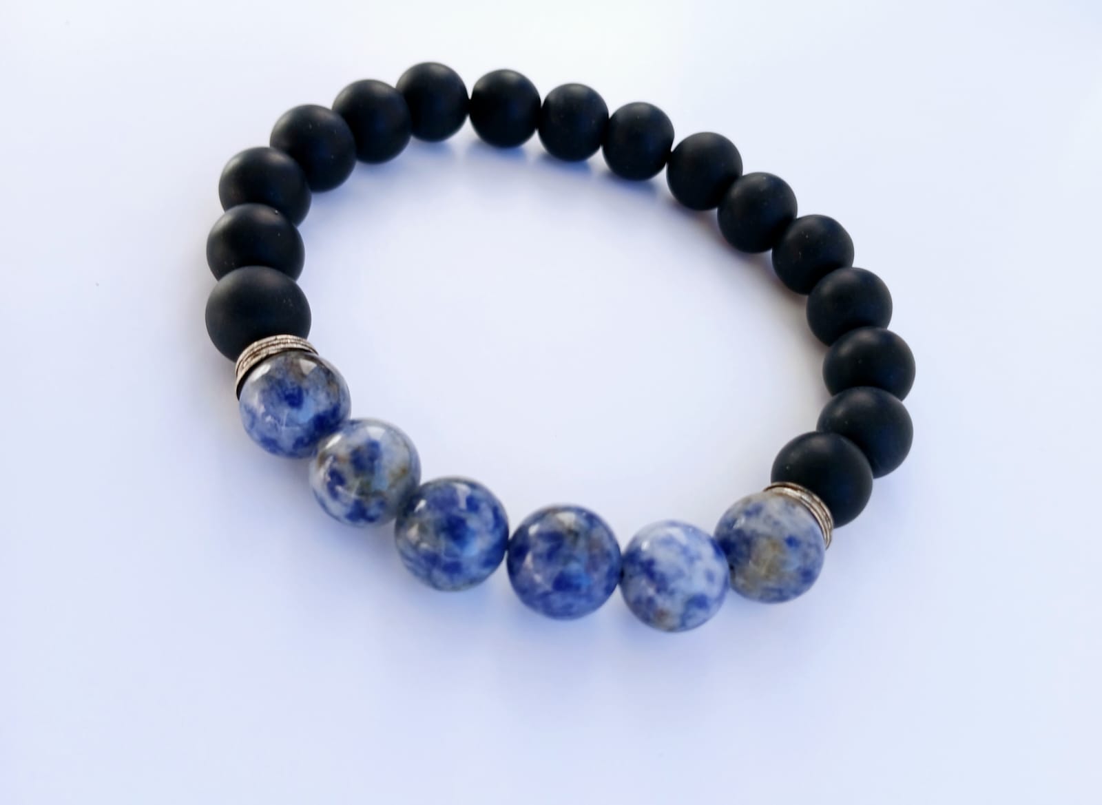 Black Onyx and Sodalite Stretch Bracelet designed for men, featuring natural stones including blue tiger eye for healing and protection. This handmade jewelry piece combines the grounding energy of onyx with the calming properties of sodalite and tiger eye, creating a stylish and meaningful accessory. Perfect as a gift for him, this stretch bracelet offers comfort, durability, and spiritual charm, ideal for everyday wear or meditation practices.