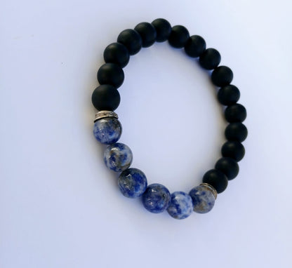 Black Onyx and Sodalite Stretch Bracelet designed for men, featuring natural stones including blue tiger eye for healing and protection. This handmade jewelry piece combines the grounding energy of onyx with the calming properties of sodalite and tiger eye, creating a stylish and meaningful accessory. Perfect as a gift for him, this stretch bracelet offers comfort, durability, and spiritual charm, ideal for everyday wear or meditation practices.