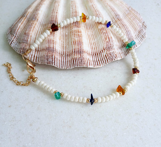 Boho Pearl Anklet for Women featuring delicate glass chip beads, handmade with care for a unique and stylish touch. This layered ankle bracelet blends coastal charm with bohemian flair, making it a perfect summer foot accessory. Ideal for beach days, festivals, or casual outings, this bohemian anklet is both lightweight and fashionable. A thoughtful gift for women who love handmade beach jewelry and boho fashion. Great for layering or wearing alone.