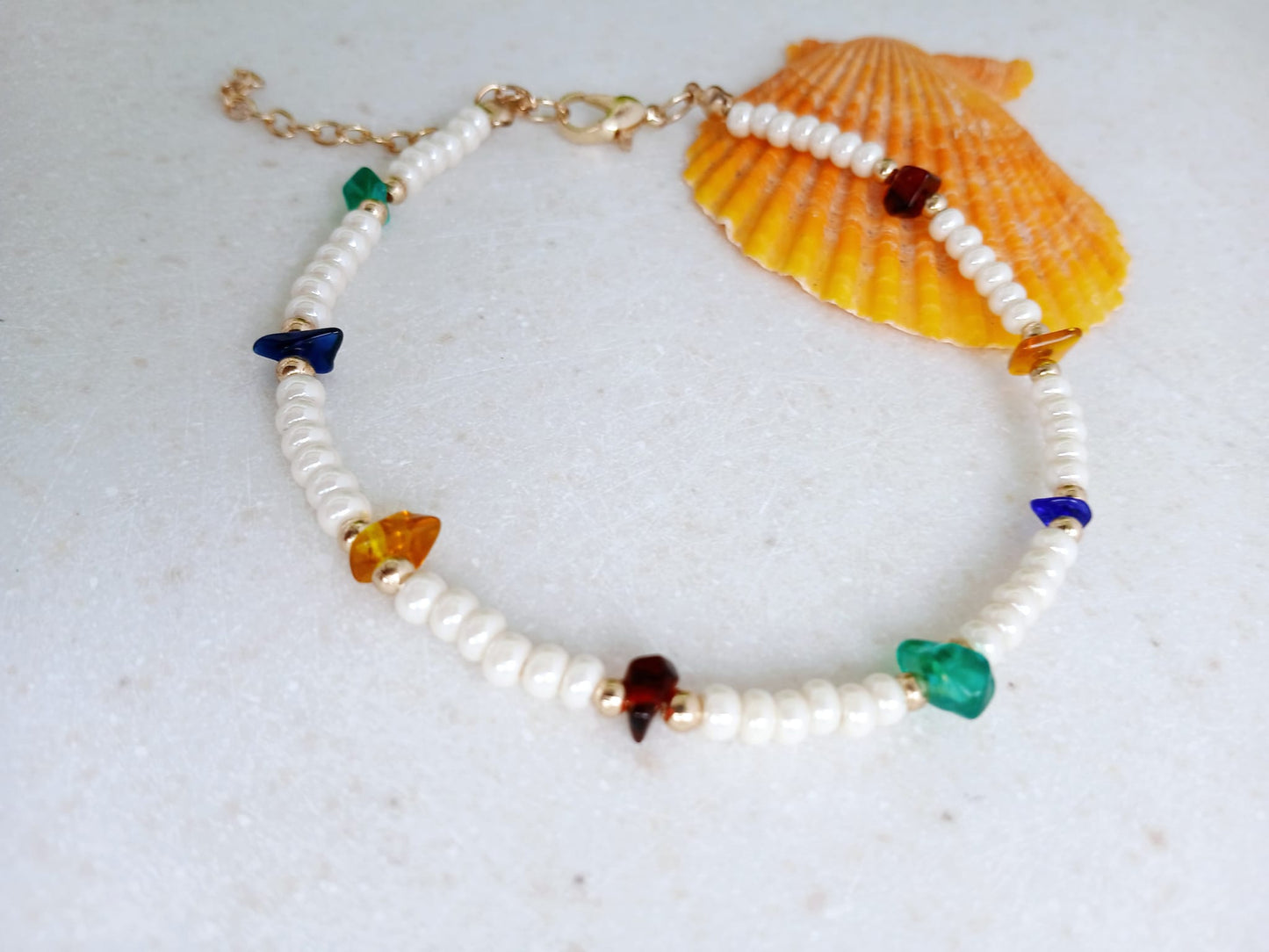 Boho Pearl Anklet for Women featuring delicate glass chip beads, handmade with care for a unique and stylish touch. This layered ankle bracelet blends coastal charm with bohemian flair, making it a perfect summer foot accessory. Ideal for beach days, festivals, or casual outings, this bohemian anklet is both lightweight and fashionable. A thoughtful gift for women who love handmade beach jewelry and boho fashion. Great for layering or wearing alone.