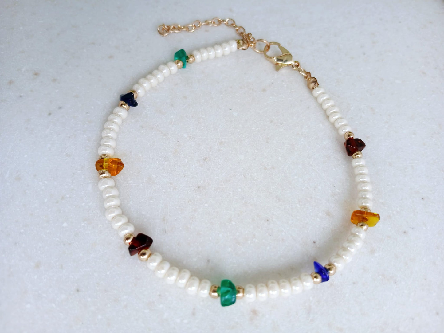 Boho Pearl Anklet for Women featuring delicate glass chip beads, handmade with care for a unique and stylish touch. This layered ankle bracelet blends coastal charm with bohemian flair, making it a perfect summer foot accessory. Ideal for beach days, festivals, or casual outings, this bohemian anklet is both lightweight and fashionable. A thoughtful gift for women who love handmade beach jewelry and boho fashion. Great for layering or wearing alone.