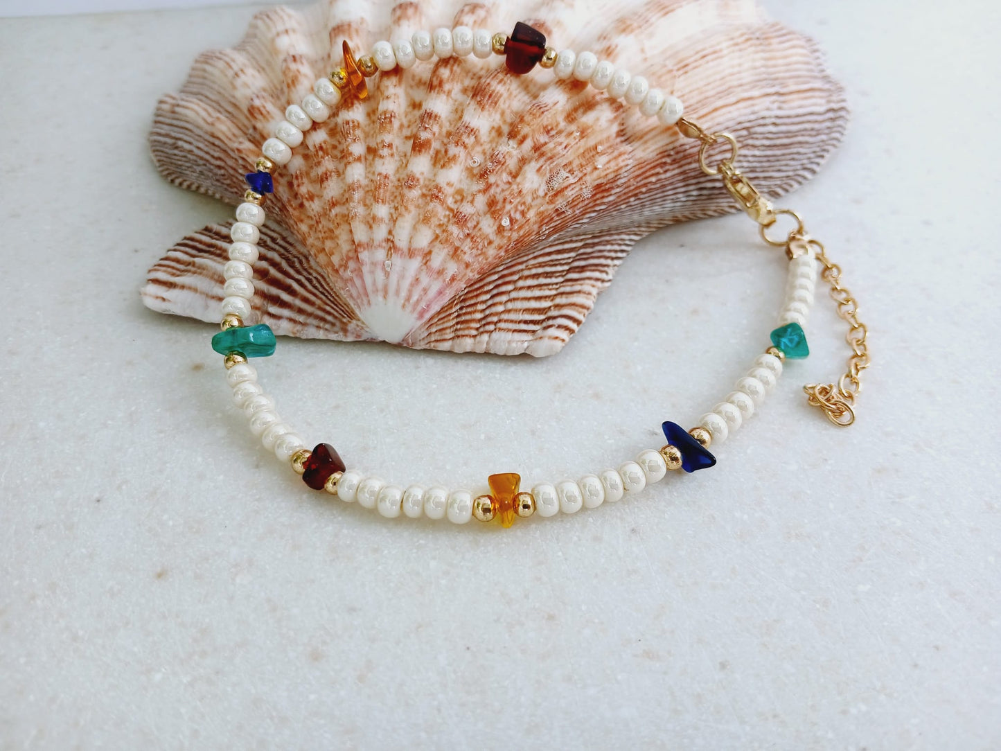 Boho Pearl Anklet for Women featuring delicate glass chip beads, handmade with care for a unique and stylish touch. This layered ankle bracelet blends coastal charm with bohemian flair, making it a perfect summer foot accessory. Ideal for beach days, festivals, or casual outings, this bohemian anklet is both lightweight and fashionable. A thoughtful gift for women who love handmade beach jewelry and boho fashion. Great for layering or wearing alone.