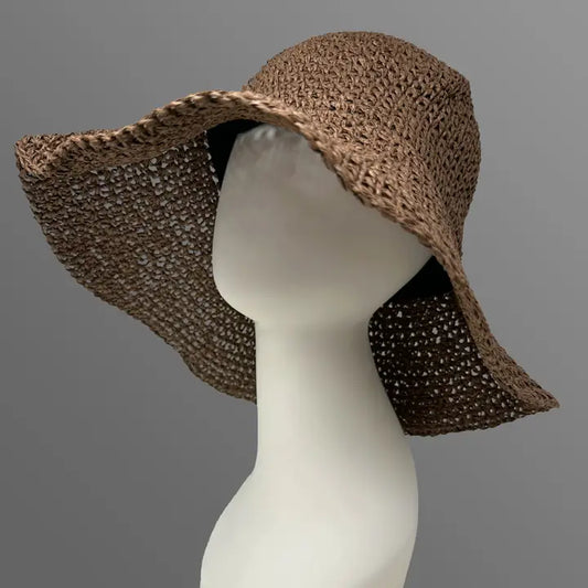 Capri straw sun hat for women in peach brown, designed with a wide floppy brim and adjustable large fit for maximum comfort and sun protection. Features a flexible wire brim to shape as desired, perfect for cottagecore summer style, beach trips, outdoor picnics, and vintage-inspired garden outfits. Lightweight and breathable, this stylish hat combines elegance with functionality for a relaxed, boho-chic seasonal look